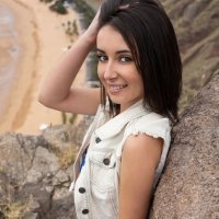 Shapely Dionisia nude at a rocky beach