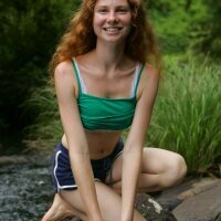 Sweet young redhead girl like an angel at the river