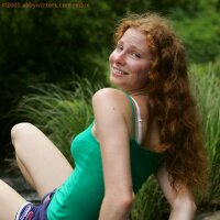Sweet young redhead girl like an angel at the river