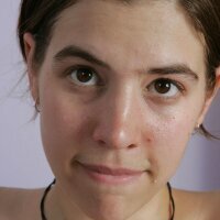 Adorable teen girl undressing in her bedroom with nice full breasts