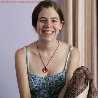 Adorable teen girl undressing in her bedroom with nice full breasts