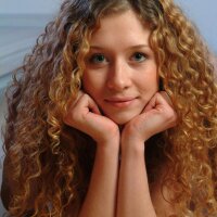 Nudes of a young radiant girl with cute curly hair