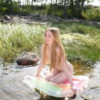 Gorgeous teenager girl Malinka playing nude with water outdoors in the sun